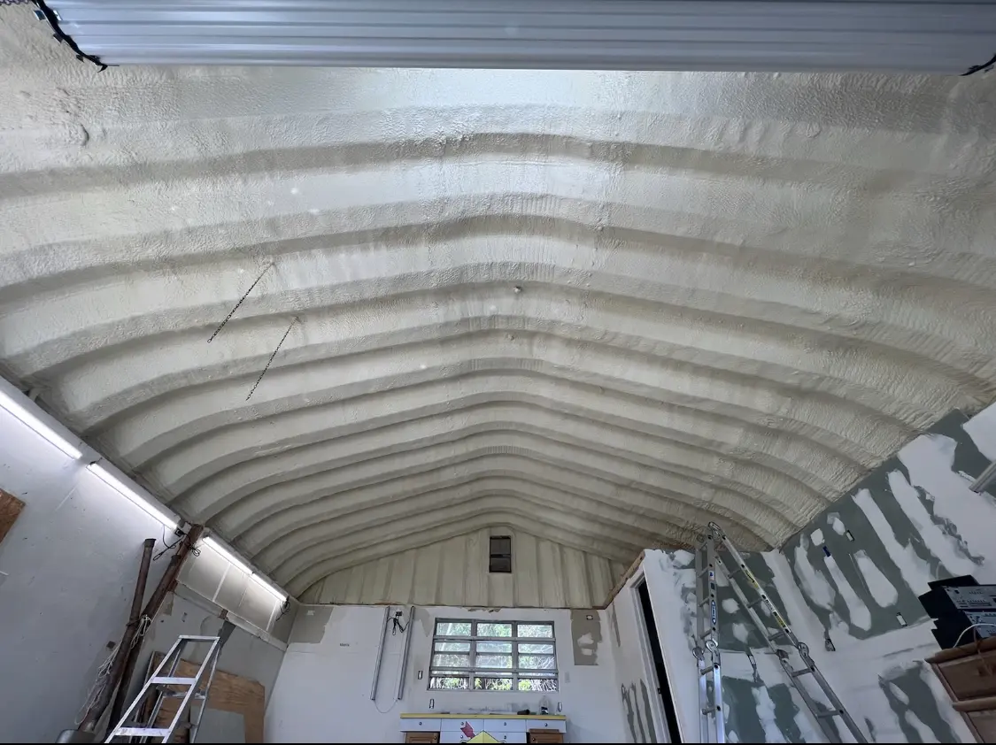 Spray polyurethane foam applied to the underside of a metal roof deck in Elburn